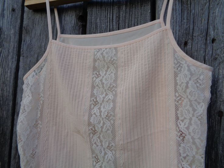 "This is a beautiful spaghetti strap top made of polyester fabric in pale peach color. Complemented with Nylon lace. Brand: St Michael made in the U.K. In excellent condition and comes from smoke-free home. Size M Labelled as size UK 14 (Eur 40; US 10) To fit bust ~36\" / 91cm Thanks for visiting my shop! OLaLaVintage Please visit my other Etsy shop of beautiful handmade items: https://www.etsy.com/shop/MilaStyle" Cream Camisole With Built-in Bra And Spaghetti Straps, Spring Lace Bodice Camisole With Spaghetti Straps, Spring Lace Bodice Camisole, Summer Lace Top With Adjustable Spaghetti Straps, Feminine Summer Camisole With Lace Bodice, Summer Camisole With Lace Bodice, Spring Lace Top With Delicate Spaghetti Straps, Summer Lace Bodice Tops With Spaghetti Straps, Beige Strappy Camisole For Spring