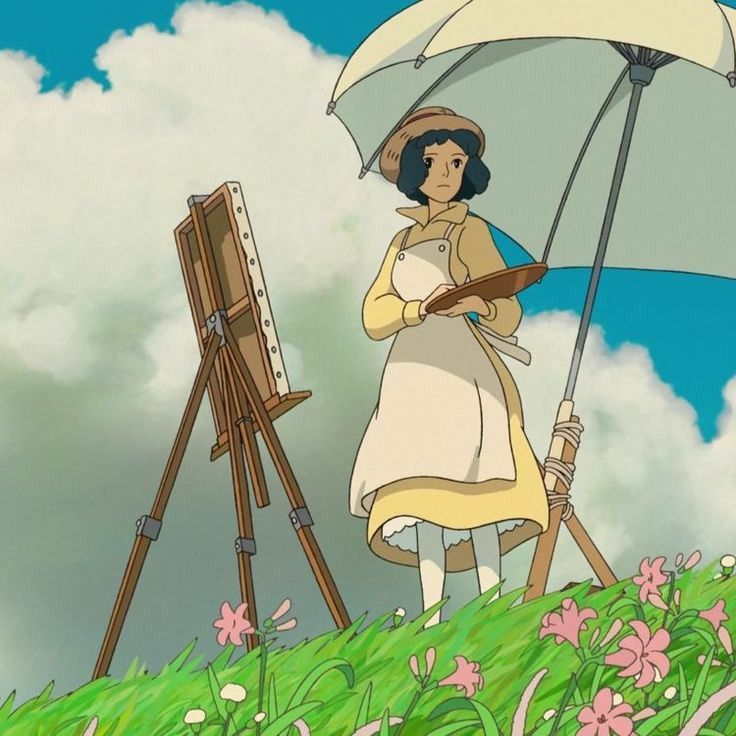 a woman holding an umbrella standing next to a easel on top of a grass covered hill