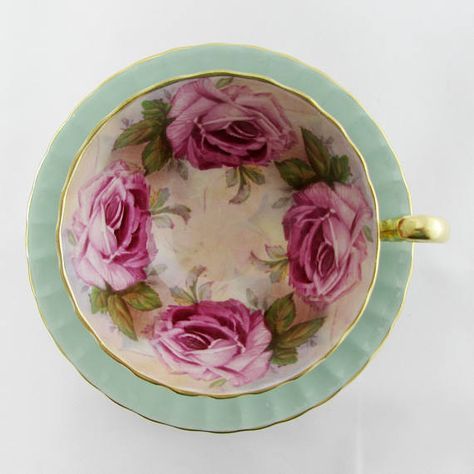 a pink and gold plate with roses on it