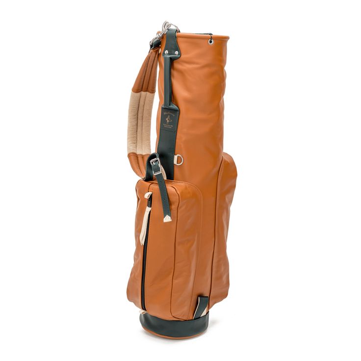 an orange golf bag sitting on top of a white floor