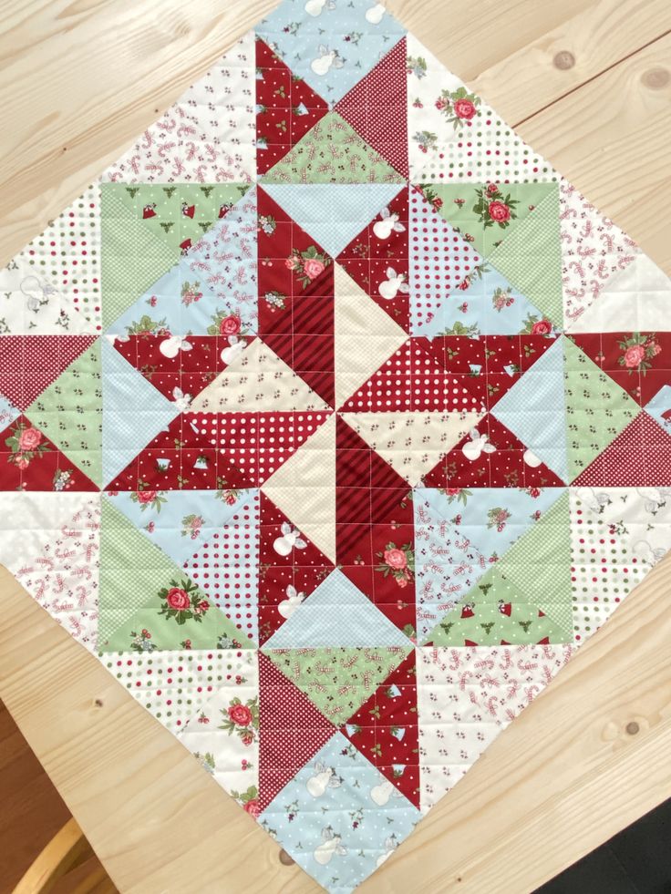 a quilted table topper on a wooden surface