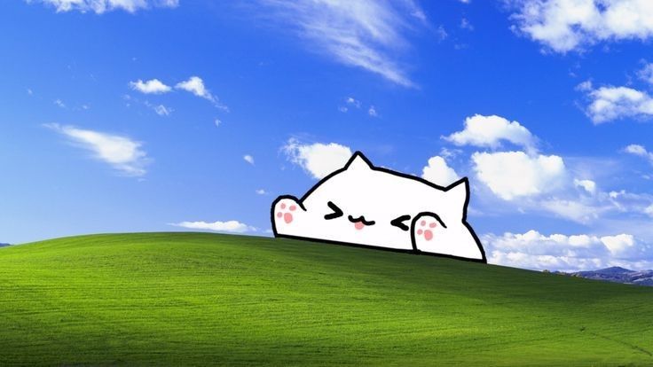 an image of a cat that is on top of a hill with clouds in the background