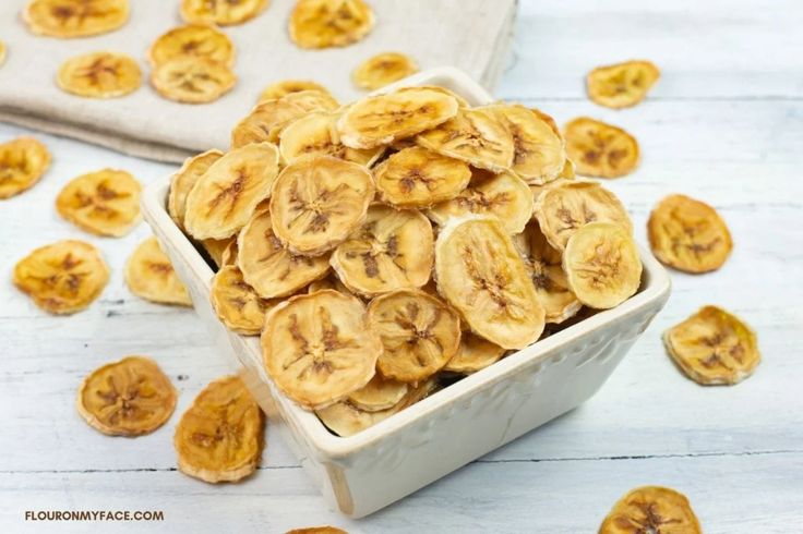 a bowl filled with sliced bananas on top of a table