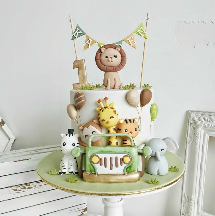 a birthday cake decorated with animals and decorations