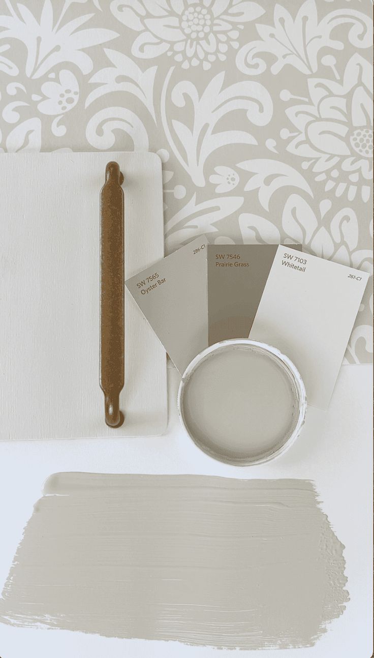 the paint is being used to create a wallpaper pattern with white and gray colors