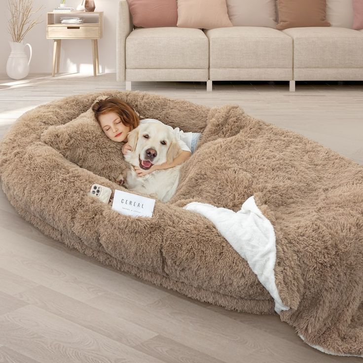 a woman in a dog bed with a white dog sitting on it's back