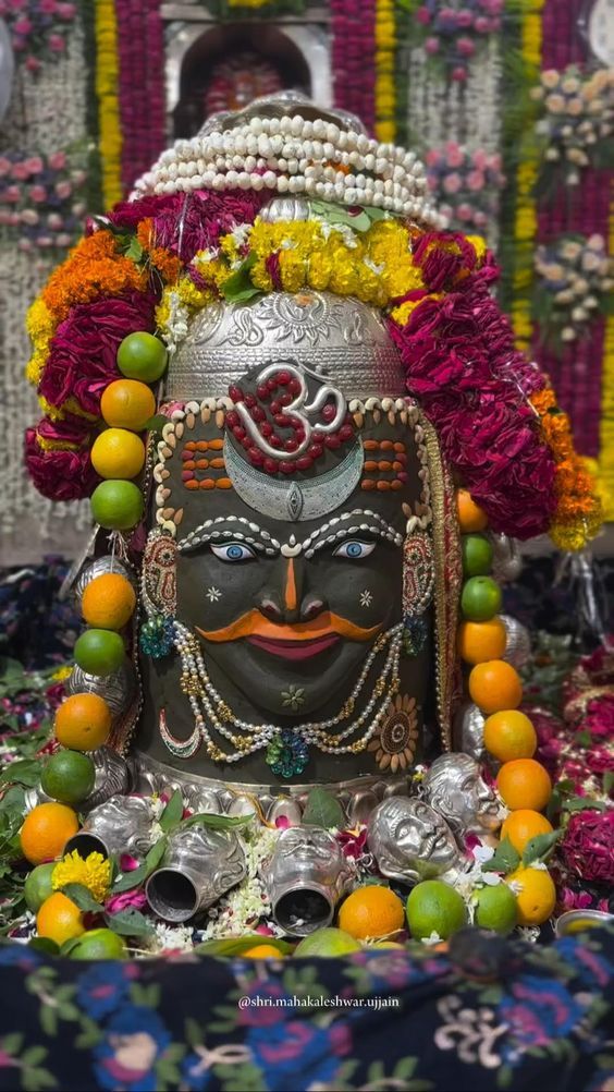 an idol is surrounded by flowers and fruit