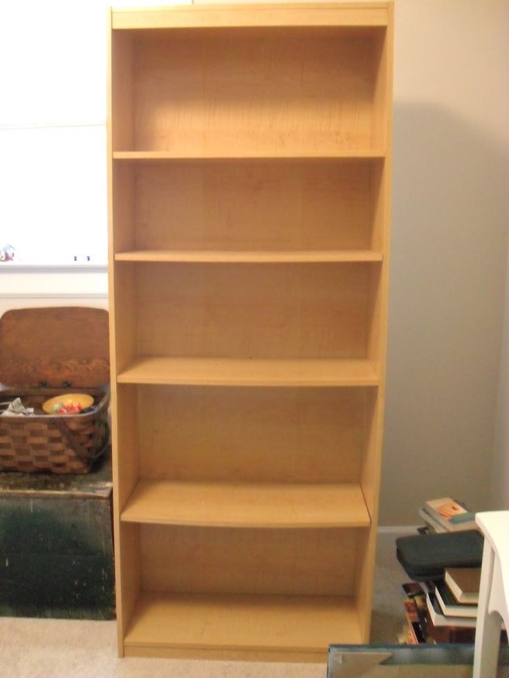 an empty book shelf in the corner of a room