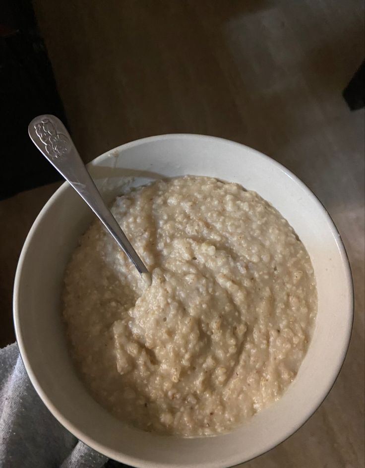 a bowl of oatmeal with a spoon in it