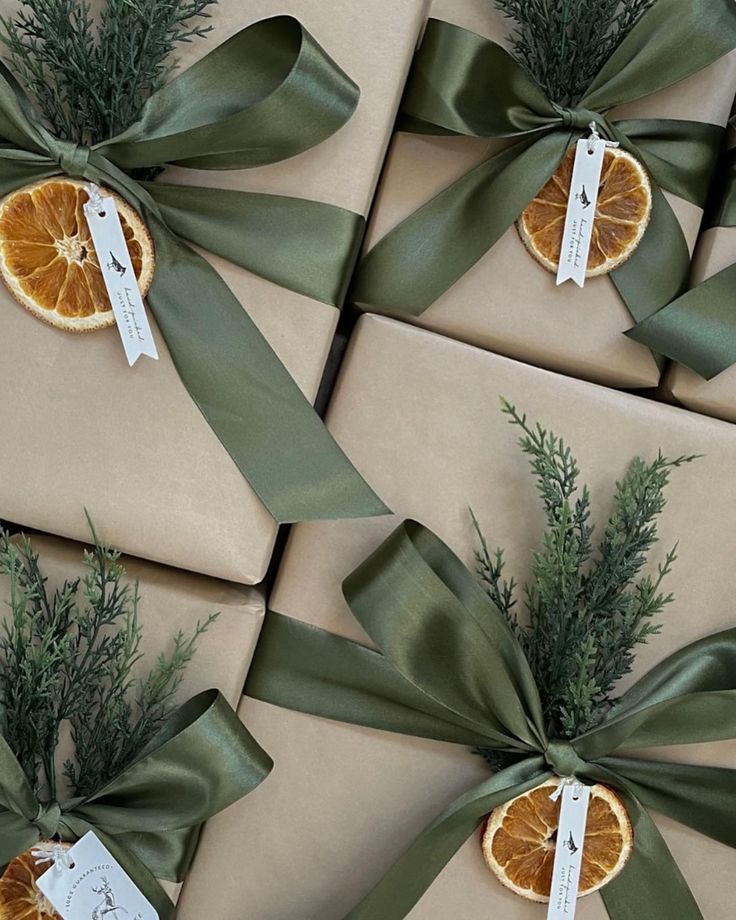 several wrapped presents with orange slices and green ribbons