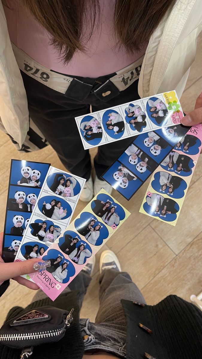 a person holding up some stickers with pandas on them