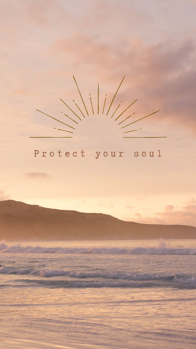 a person walking on the beach carrying a surfboard under an orange and pink sky