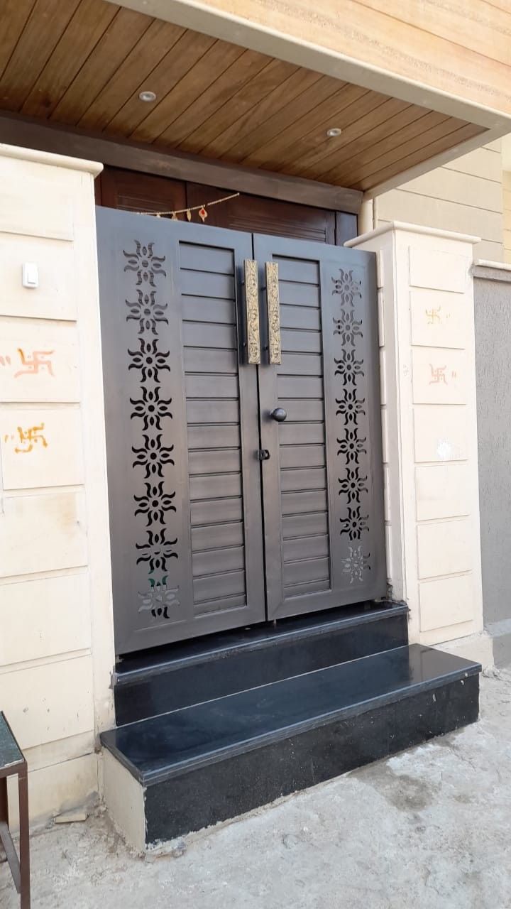 the front door of a building with two doors and steps leading up to it's entrance