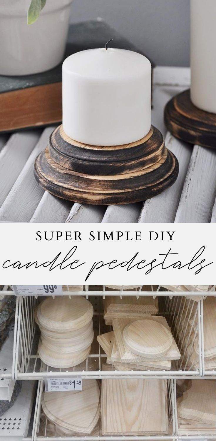 a white candle sitting on top of a table next to some wooden plates and bowls