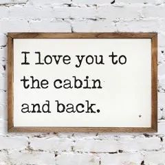 a sign that says i love you to the cabin and back on a white brick wall