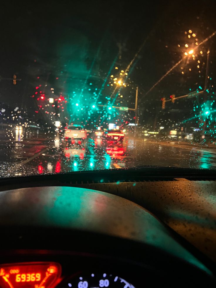 the dashboard of a car on a rainy night