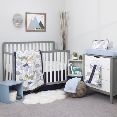 a baby's room with a crib, dresser and bedding in it