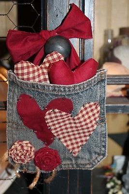 an old pair of jeans has been decorated with red hearts and roses in the pocket