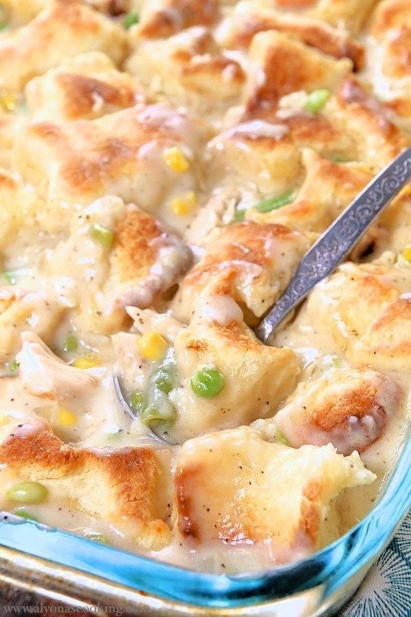 a casserole dish with chicken and vegetables in it is being spooned into the casserole