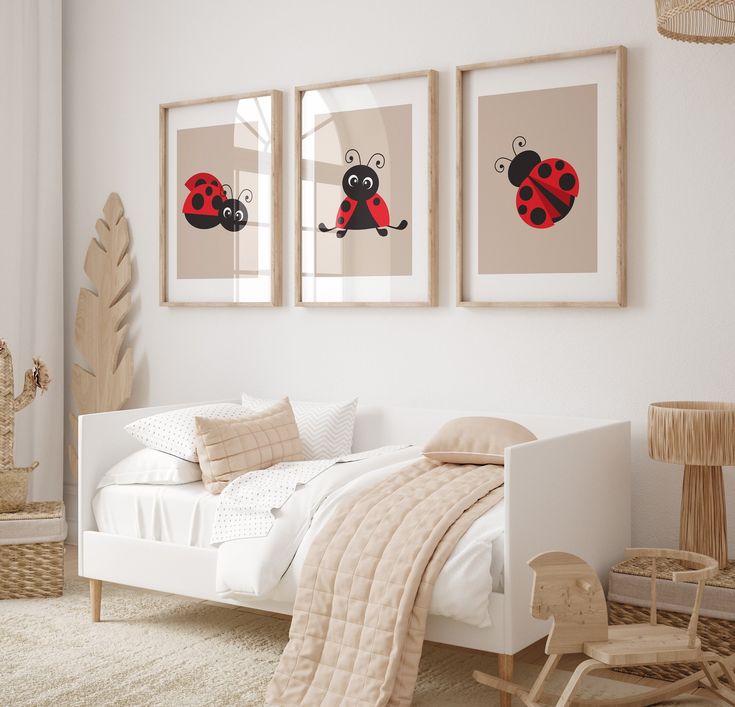 two framed pictures hang above a bed in a room with white walls and carpeted flooring