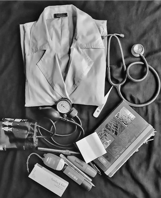 black and white photograph of doctor's supplies including an umbrella, stethoscope