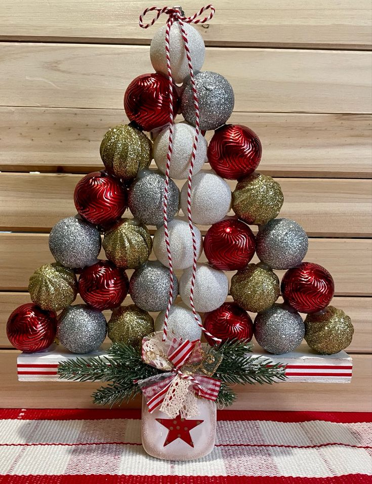 a christmas tree made out of balls and candy canes