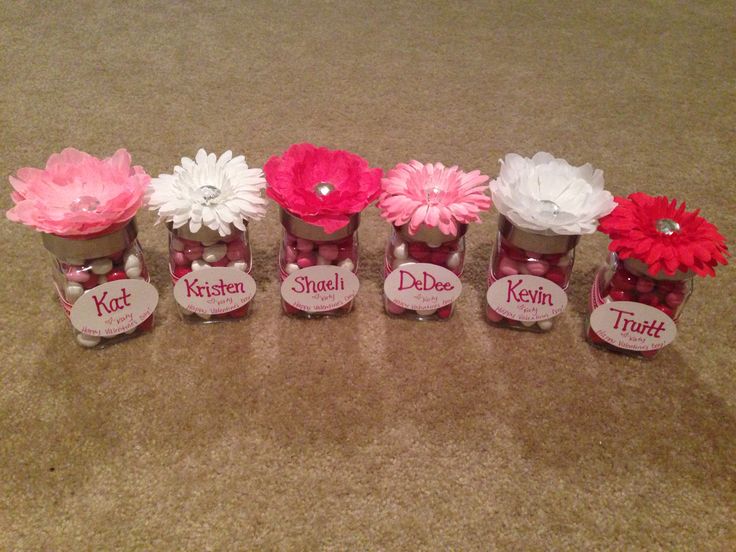 a group of small vases with flowers in them