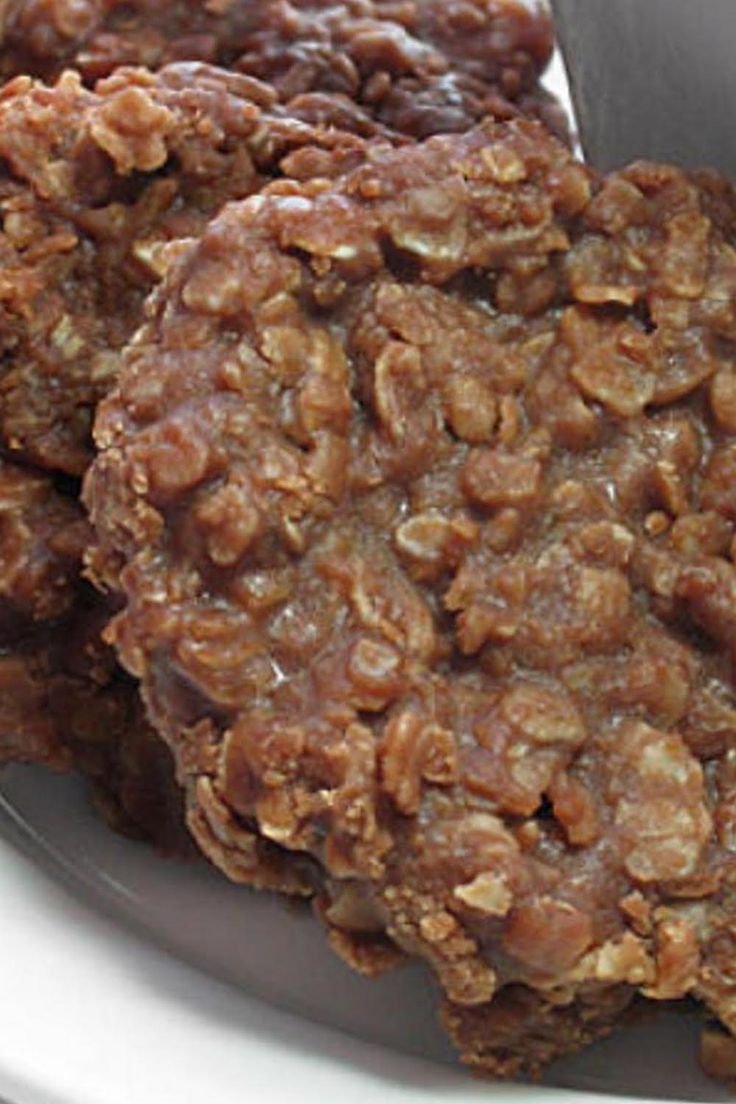 three cookies sitting in a bowl on top of a table