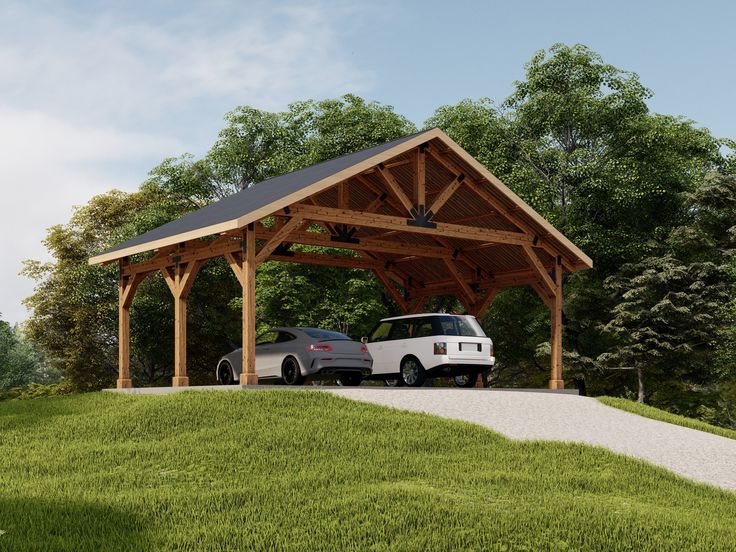 a car is parked under a wooden covered structure in the grass next to a white van