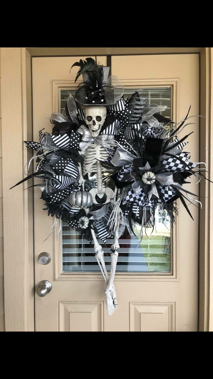 a skeleton wreath is hanging on the front door