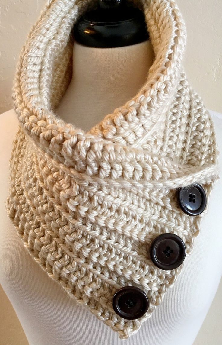 a crocheted cowl with buttons on it