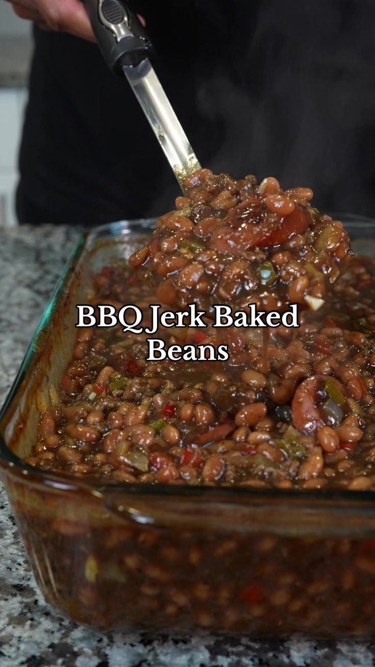 a person is cooking beans in a glass casserole dish with the words bbq / jerk baked beans above it