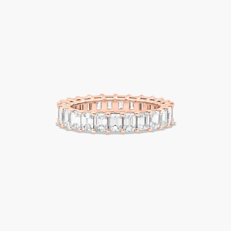 14K Rose Gold Emerald Cut Diamond Eternity Ring (3 CTW H-I / SI1-SI2). This timeless eternity ring features the boldness and elegant gleam of emerald cut diamonds. A classic, tailored shared prongs setting allows the maximum amount of the diamonds surface to show. Number of diamonds and carat total weight will vary depending on ring size. Yellow Sapphire Rings, Diamond Eternity Ring, Rings Mens Wedding Bands, Classic Wedding Rings, Platinum Wedding Rings, Pink Sapphire Ring, Princess Cut Rings, Round Cut Engagement Rings, Diamond Anniversary Rings