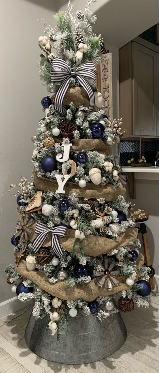 a christmas tree decorated with blue and white ornaments