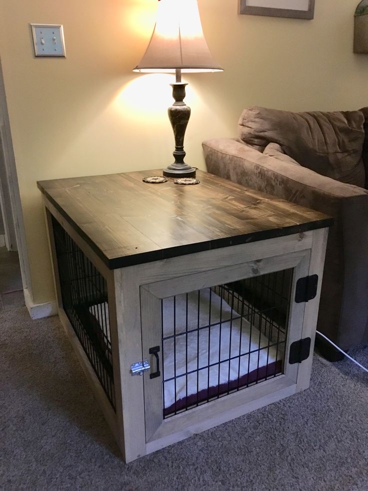 a dog crate with a lamp on top of it