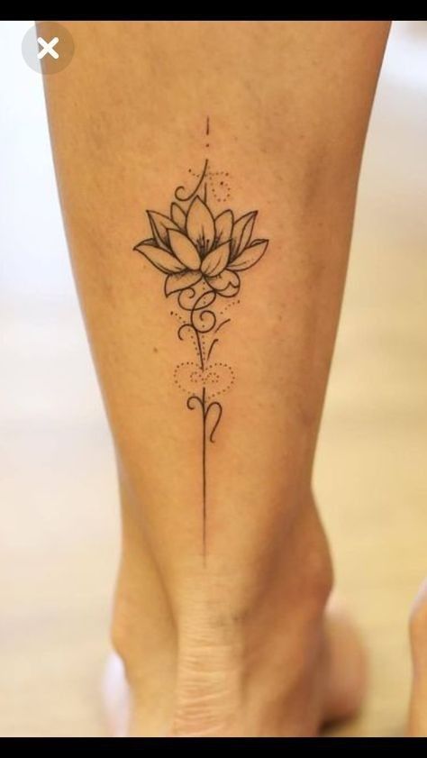 a woman's foot with a flower tattoo on the side of her leg,