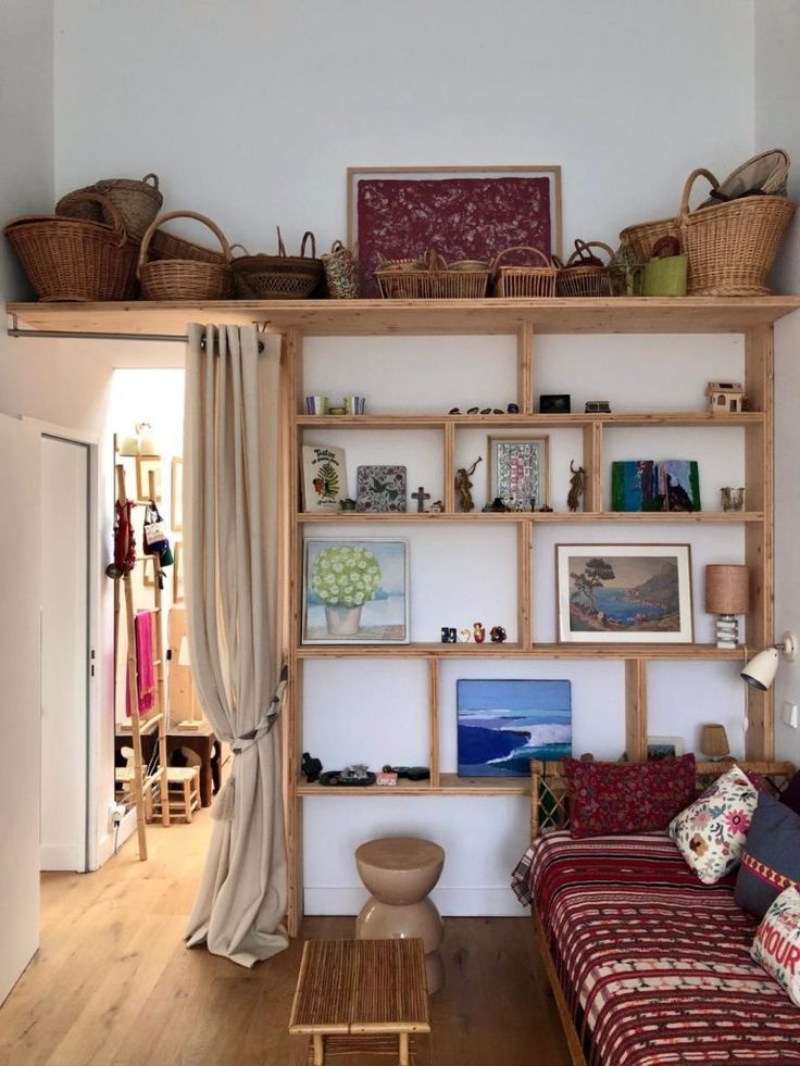 a living room filled with furniture and lots of shelves