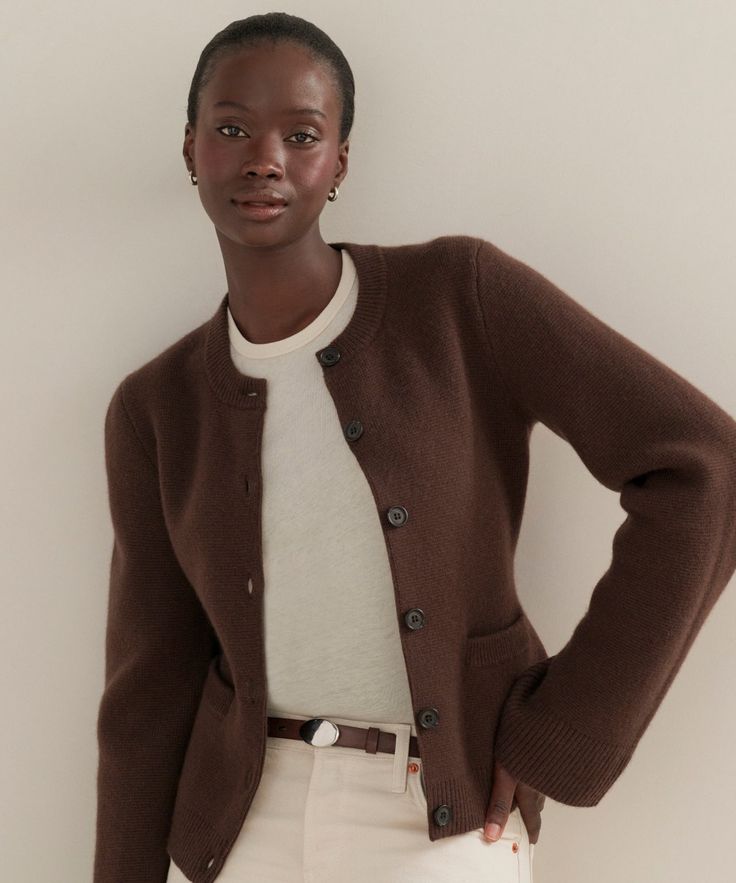 Cooper Cardigan Chocolate Featuring a structured silhouette that nips in at the waist and a very slight bell sleeve that instantly elevates any ensemble, this iconic cardigan effortlessly holds its own in any wardrobe. The fitted body enables versatile styling: wear it open like a blazer with a t-shirt underneath or buttoned up as a pullover. Classic Fitted Solid Sweater Coat, Classic Fitted Sweater Coat, Classic Fitted Sweater Coat For Work, Classic Winter Cardigan With Hidden Button Closure, Fitted Sweater Coat With Button Closure For Work, Elegant Winter Cardigan With Hidden Buttons, Classic Cardigan With Hidden Button Closure For Work, Elegant Brown Sweater Coat For Layering, Fitted Classic Cardigan For Layering