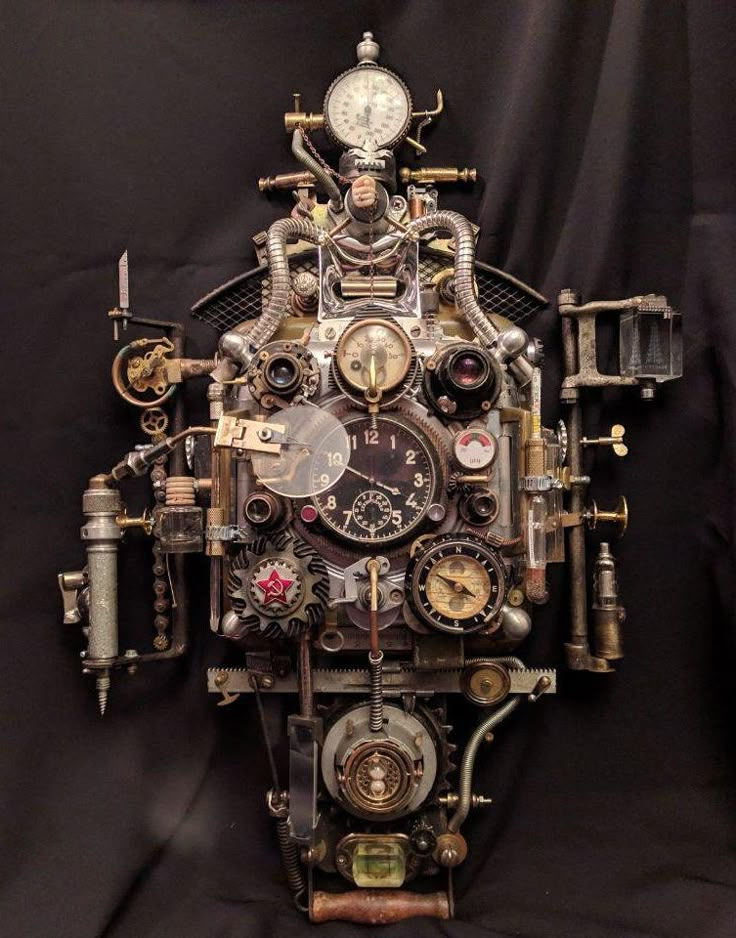 a clock made out of assorted parts on a black background