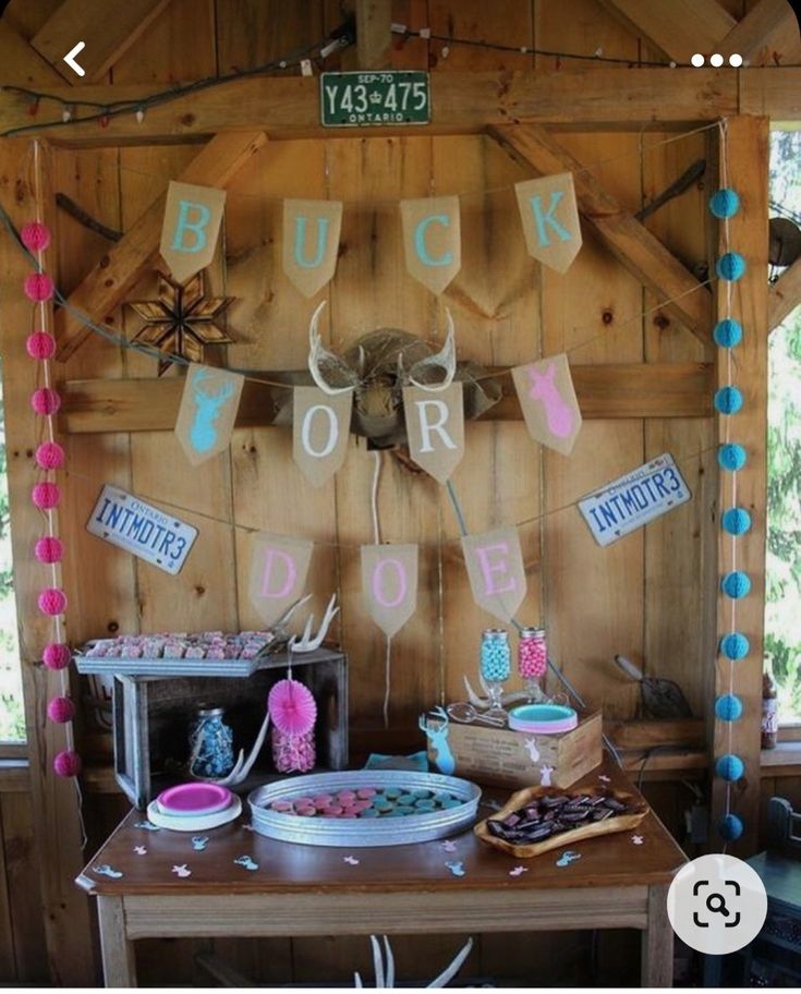 a wooden table topped with lots of cake and desserts next to a sign that says buck for donuts