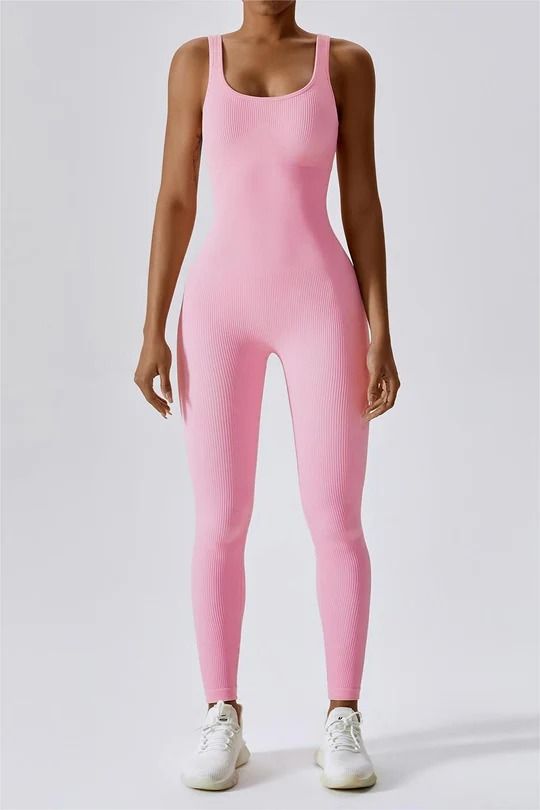 Made from our seamless ribbed material, this body-hugging bodysuit is ideal for a range of activities including yoga, fitness classes, and even everyday errands. Its sleeveless design boasts a flattering plunge neckline and an open back that allows for optimal ventilation during even the most vigorous workouts. With it Sporty Seamless Sleeveless Bodysuit, Sleeveless Pink Workout Bodysuit, Compressive Sleeveless Sports Bodysuit, Micro-elastic Sleeveless Bodysuit For Yoga, Pink High-stretch Sleeveless Activewear, Plunging Neckline