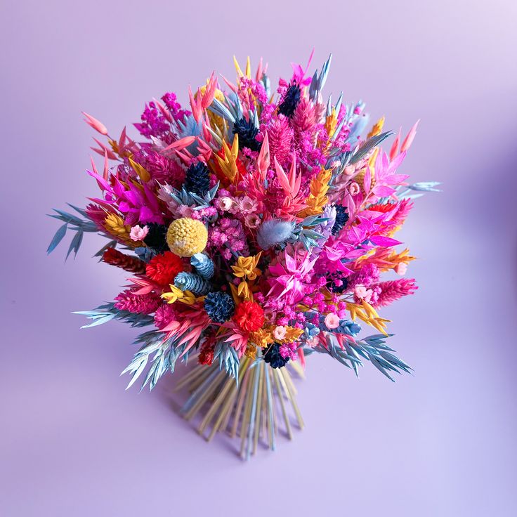 a bouquet of colorful flowers on a purple background