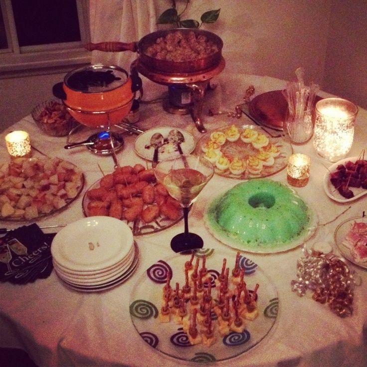 a table topped with lots of different types of desserts and pastries on plates