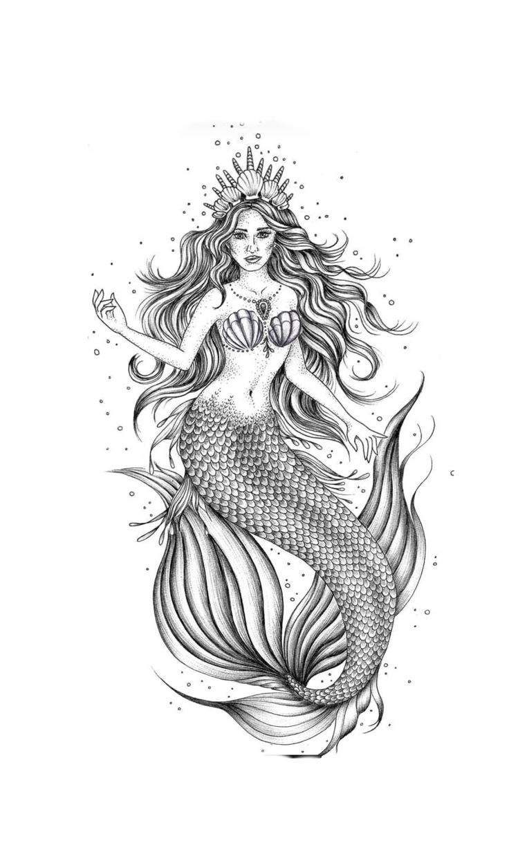 a drawing of a mermaid sitting on top of a wooden table