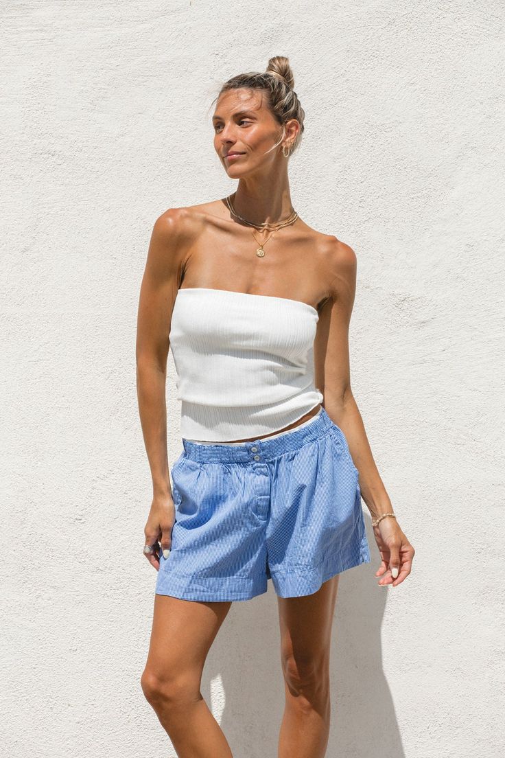 Expertly crafted with a ribbed knit, our High Noon Tube Top offers both comfort and versatility. Its long length provides ample coverage and pairs well with high-waisted bottoms. Perfect by itself or to layer under a breezy button up, this white sweater tube top is a must-have for any wardrobe. Ribbed Loungewear Tops, Ribbed Short Length Tops For Loungewear, Ribbed Stretch Top, Short Length, Ribbed Stretch Short Tops, Ribbed Stretch Short Length Tops, Chic Ribbed Short Length Bottoms, Spring Cotton Ribbed Bottoms, Spring Ribbed Cotton Bottoms, Summer Seamless Relaxed Fit Bottoms