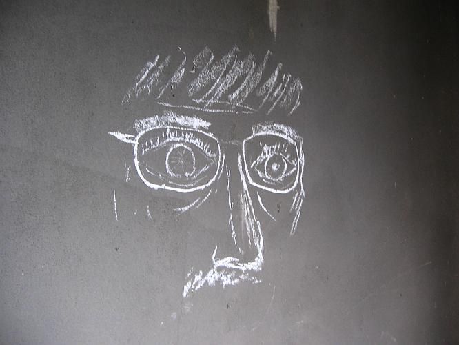 a chalk drawing of a man's face with glasses