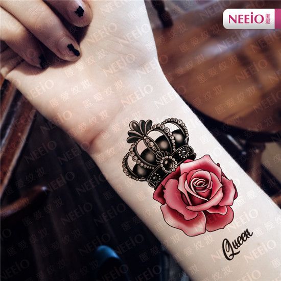 a woman's arm with a rose and crown tattoo on it