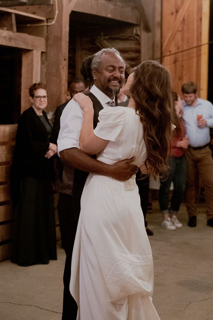 an older man and woman dance together on the dance floor in front of other people