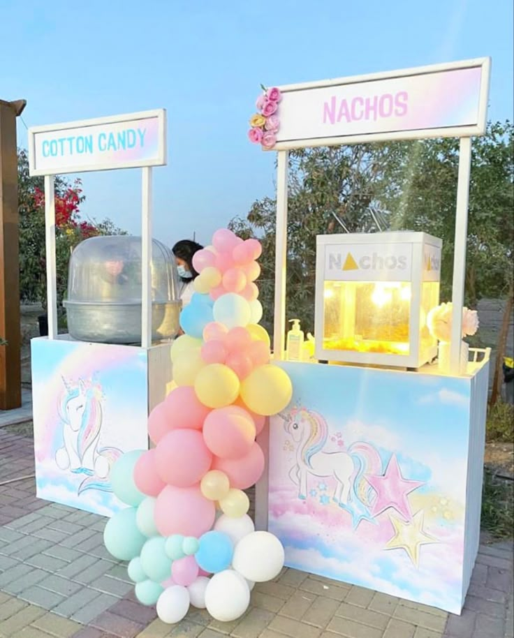 an ice cream stand with balloons on it