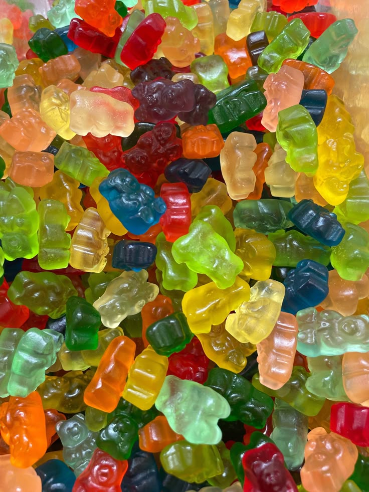 a pile of gummy bears sitting next to each other